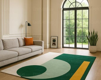 May include: A modern area rug with a geometric design. The rug features a large green section with a light green circle and a yellow rectangle. The background is off-white. The rug is placed in a living room with a sofa and large window.