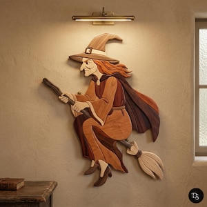 May include: Wooden wall art of a witch riding a broom. The witch is wearing a brown hat, cape, and dress, with red hair. The broom is made of light-colored wood. The art is mounted on a beige wall, with a light fixture above.