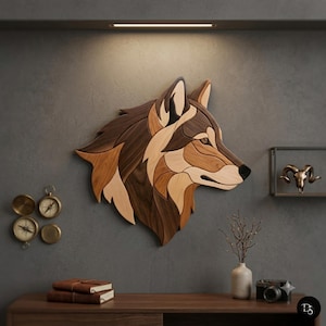 May include: A wall-mounted wooden wolf head sculpture composed of layered, multi-toned wood pieces in shades of dark brown, medium brown, and light tan, featuring a profile view of the animal with a black nose and detailed wood grain patterns.