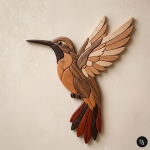 May include: Wooden hummingbird wall art. The bird is crafted from various wood tones, including light tan, medium brown, and dark brown. The wings are spread, and the tail feathers are a mix of red and brown. The hummingbird is mounted on a light beige background.