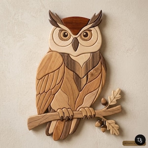May include: Wooden owl wall art. The owl is perched on a branch with acorns and leaves. The artwork is made of various shades of wood, including light and dark browns. The owl has large, detailed eyes and a textured appearance.