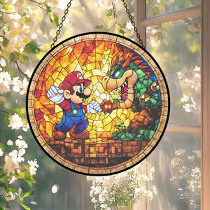 May include: A circular stained glass window depicting Mario and Bowser from the Super Mario video game. The artwork shows the characters in a dynamic pose against a colourful, mosaic-like background. The window is framed in a dark border and hangs from a chain.