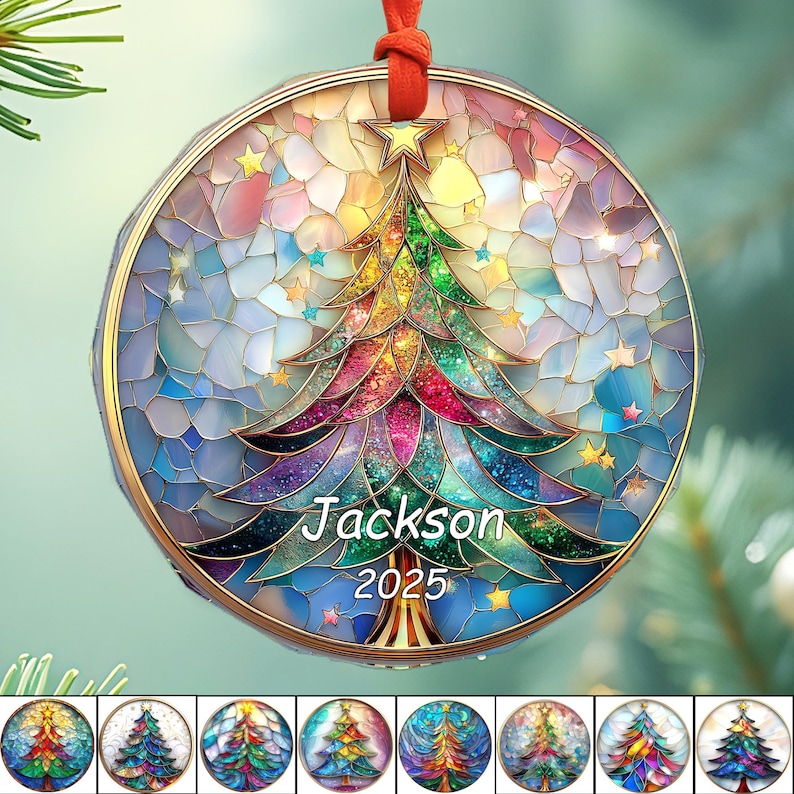 May include: A round Christmas ornament with a stained-glass design featuring a colorful Christmas tree and stars. The ornament has the name "Jackson" and the year "2025" printed on it. It is suspended by a red ribbon.