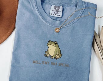 「まあ、それは特別なことじゃない」Tシャツ、皮肉なカエルのグラフィックTシャツ、ミニマルなデッドパンユーモアシャツ