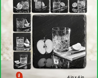 May include: Black and white image of nine slate coasters, each featuring a different design. The coasters showcase a glass of liquid with fruit and other garnishes. Each coaster is 4 in x 4 in.