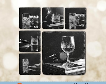 May include: Six black and white square coasters with different designs. Each coaster features a glass of whiskey, a camera, or a turntable. The coasters are 4 inches by 4 inches.