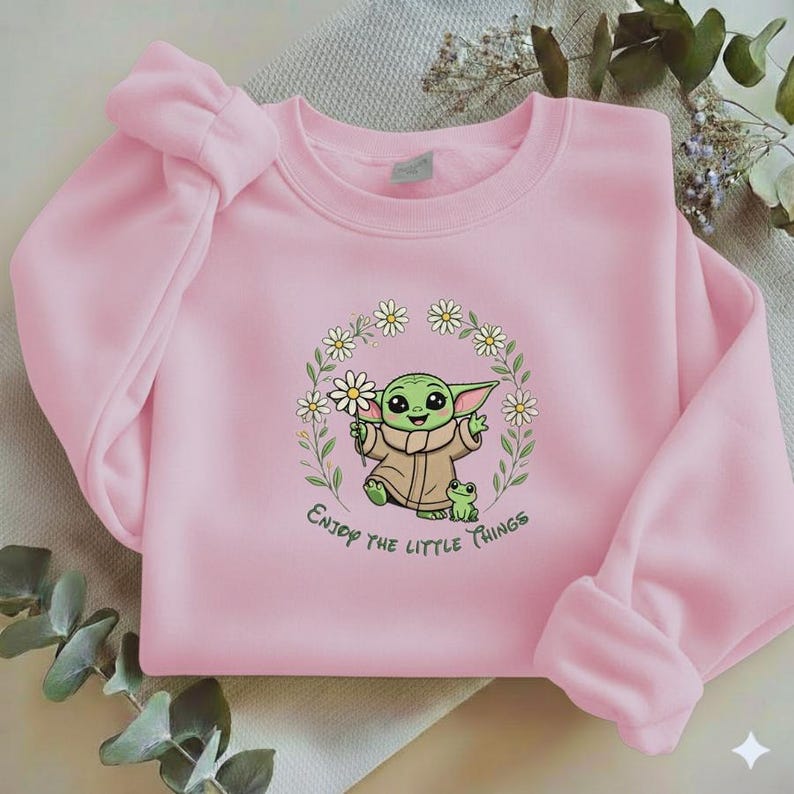 May include: A white ceramic mug with a black handle and the text "But First, Coffee" in a bold, black font. The mug is set against a blurred background, suggesting a cozy setting.