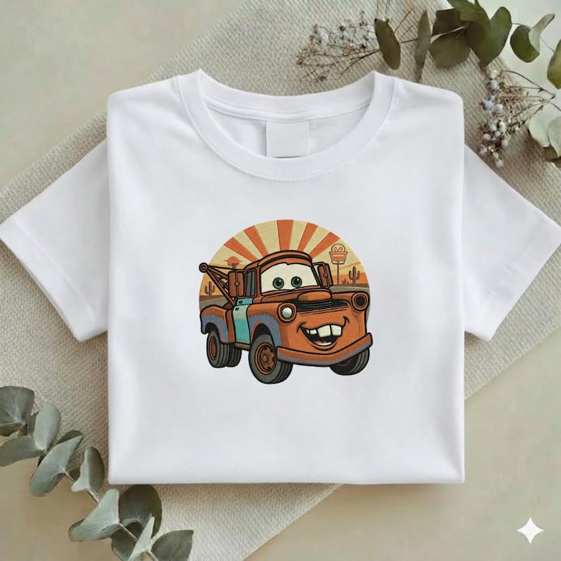 May include: A white ceramic mug with a black handle and the text "But First, Coffee" in a black, handwritten-style font. The mug is on a white surface.