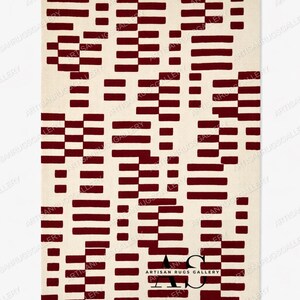 May include: Rectangular area rug with a cream background and a repeating pattern of burgundy-colored rectangular blocks. The blocks vary in size and arrangement, creating a geometric design. The rug has the text "ARTISAN RUGS GALLERY" at the bottom.
