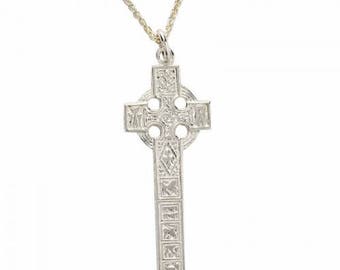 May include: A silver Celtic cross pendant necklace with intricate knotwork designs. The cross is suspended from a silver chain.