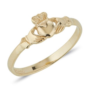 Dainty Gold Irish made Claddagh ring. In the centre of the ring is two gently cupped hands holding a heart, with an intricate crown resting above the heart. Ring has a polished, shiny finish.