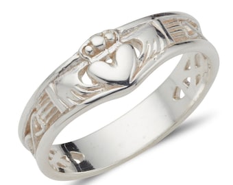 May include: A silver Celtic knot ring with a heart and two hands clasped together. The ring is a traditional Irish design.