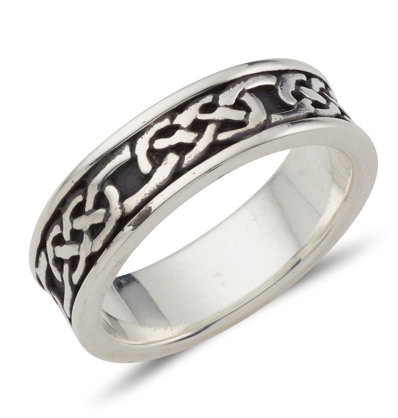 Sterling Silver Irish made Claddagh band with Galway Knot design.  The background of the ring is oxidised to black so as to bring out the silver of the Celtic design surrounding the entirety of the band. Two plain rims border the band.