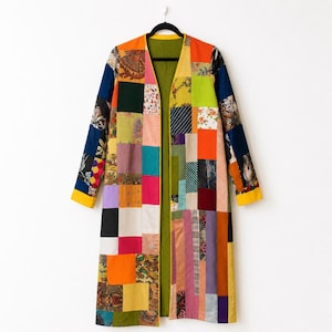 May include: A long-sleeved open-front coat constructed from a patchwork of various rectangular fabric pieces in diverse colors including orange, yellow, green, blue, pink, and black, featuring a mix of solid colors and floral or geometric patterns.
