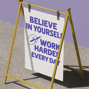 May include: A-frame sign with a yellow frame and a white sign. The sign has the text "BELIEVE IN YOURSELF! WORK HARDER EVERY DAY" in blue. A drawing of a hand holding a pen is also on the sign.