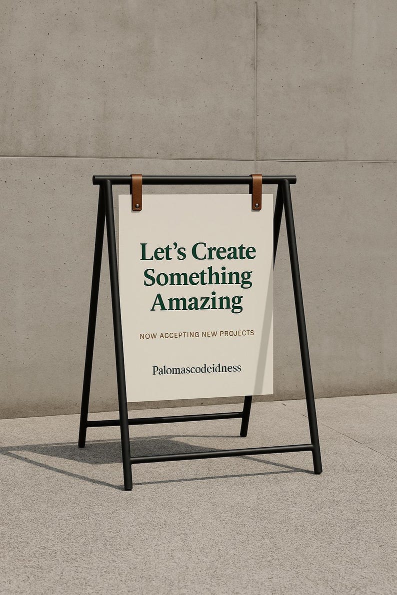 May include: A-frame sign with a black metal frame and a white sign. The sign has the text "Let's Create Something Amazing" in dark green. The sign also says "Now Accepting New Projects" and "Palomascodeidness".