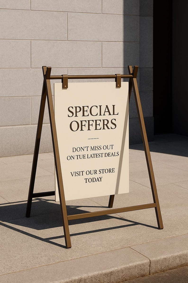 May include: A-frame sign with a cream-colored sign that reads "SPECIAL OFFERS." Below the title, the sign says "DON'T MISS OUT ON TUE LATEST DEALS" and "VISIT OUR STORE TODAY." The sign is supported by a bronze-colored metal frame.