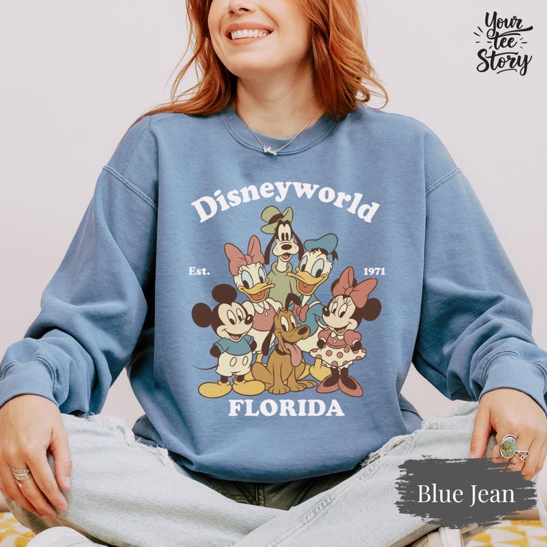 May include: A white ceramic mug with a black handle and the text "But First, Coffee" in a black, bold font. The mug is on a white surface.