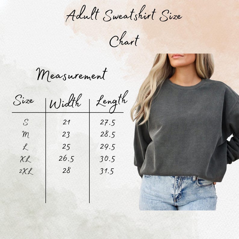 May include: A size chart for adult sweatshirts, with measurements in inches. The chart includes sizes S, M, L, XL, and 2XL, with corresponding width and length measurements. A person is wearing a dark gray sweatshirt and blue jeans.