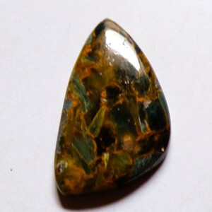 May include: A polished, triangular gemstone with a mix of colours. The stone features a blend of dark green, brown, and gold hues, with a glossy surface. The gemstone's unique pattern and shape make it suitable for jewellery or collection.