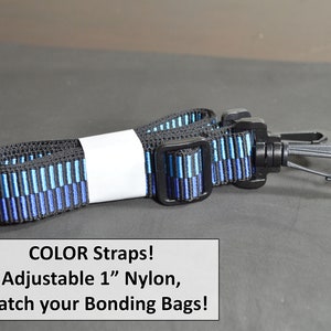 May include: Adjustable 1-inch nylon strap with black, blue, and teal vertical stripes. The strap has black plastic hardware and a metal clip on each end. The text on the image reads: "COLOR Straps! Adjustable 1" Nylon, Match your Bonding Bags!"