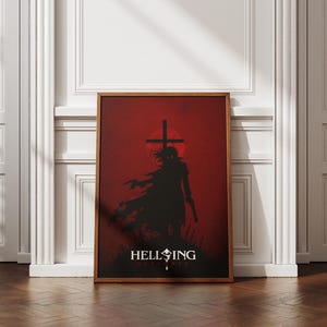 May include: A framed vertical poster featuring a dark silhouette of a character holding a firearm against a deep red background. A large cross is positioned behind the figure, and the text HELLSING ULTIMATE is printed in white at the bottom.