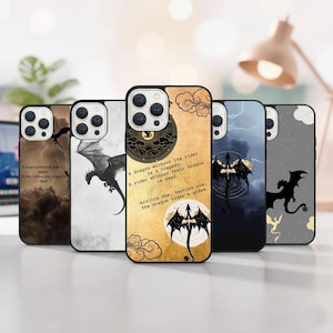 May include: A collection of phone cases with dragon-themed designs. Each case features a different dragon illustration in black and white, with quotes about dragons. The cases have a glossy finish and are displayed on a white surface.
