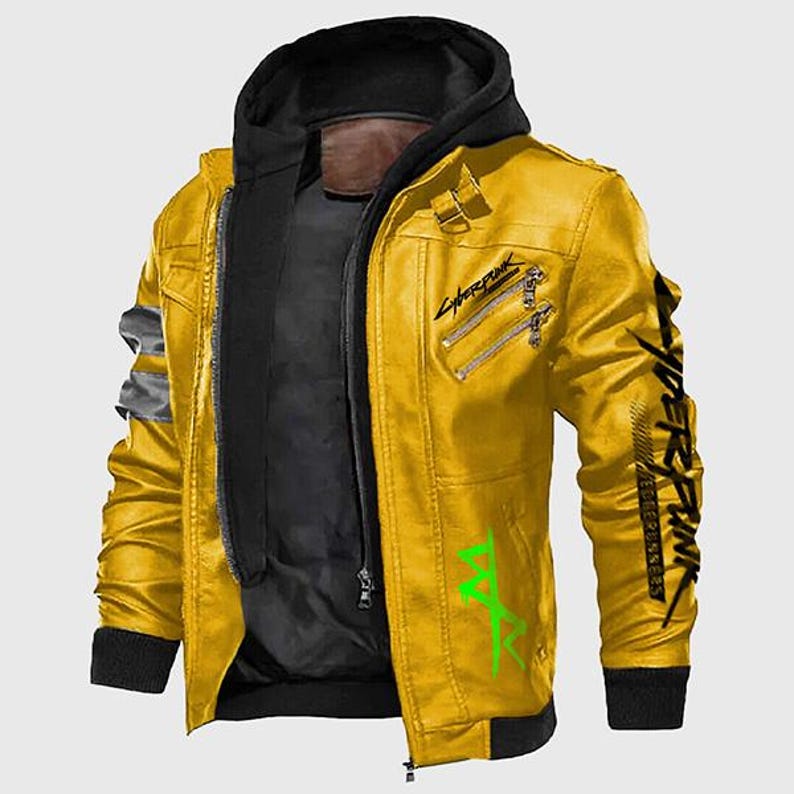 May include: A yellow leather jacket with a black hood and a black inner layer. The jacket features silver zippers, a black collar, and green and black text graphics on the sleeves and front. The jacket has a bomber style.