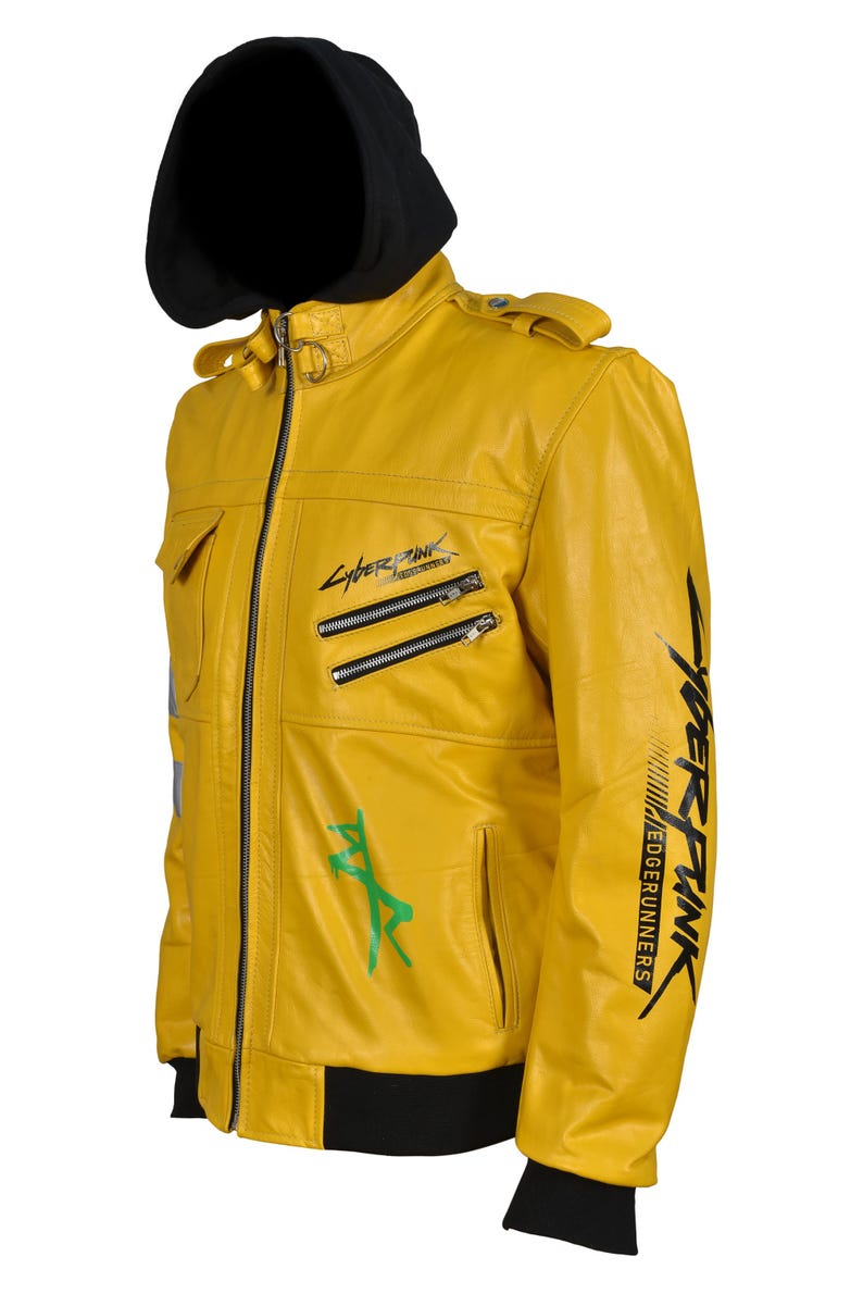 May include: A yellow leather jacket with a black hood. The jacket features multiple zippers, pockets, and green and black graphics. The text "Cyberpunk Edgerunners" is printed on the jacket.