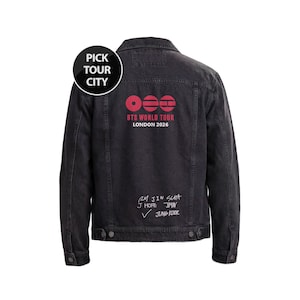 May include: A black denim jacket featuring a back graphic with three red circular icons, the text "BTS WORLD TOUR LONDON 2026", and a list of names including RM, JIN, SUGA, J HOPE, JIMIN, and JUNG KOOK. A circular badge reads "PICK TOUR CITY".