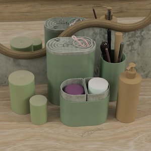 May include: A collection of sage green bathroom accessories, including cylindrical containers, a divided box with purple and white contents, a pump bottle, and a holder with makeup brushes. A round mirror is in the background.