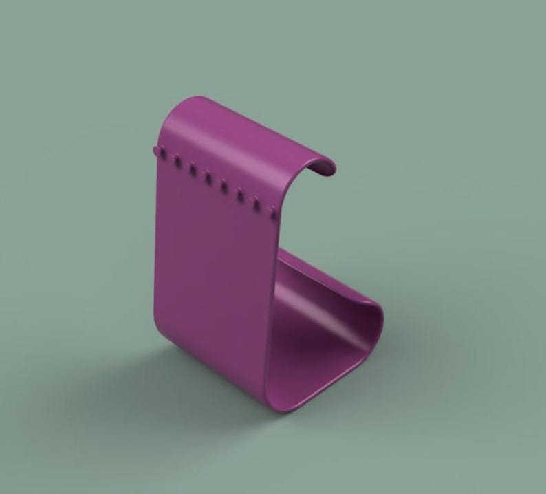 May include: A magenta-colored, curved, modern-style phone stand. The stand has a rectangular base and a curved top, with a series of small, evenly spaced holes along the edge. The stand is made of a smooth, solid material.
