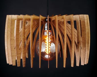 May include: A wooden pendant light fitting with a distinctive design. The light features a series of curved wooden slats arranged around a central light bulb. The bulb is a warm, amber colour, and the fitting hangs from a black cord.