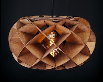 May include: A wooden pendant light fitting with a geometric design. The light has a spherical shape with a lattice pattern made of wooden slats. An Edison-style light bulb is visible inside the fitting, and it hangs from a black cord against a dark background.
