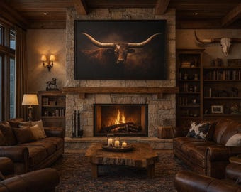 May include: A large rectangular wall art print featuring a brown longhorn steer against a dark background, mounted above a stone fireplace. The artwork is framed in black and displays a detailed portrait of the animal with prominent horns.