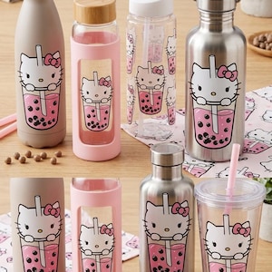 May include: Collection of water bottles and tumblers featuring a Hello Kitty design with a pink boba tea graphic. The bottles are in various colors, including silver, pink, and clear, with different lid styles. Pink straws are also visible.