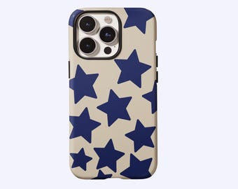 May include: A beige phone case featuring a pattern of navy blue stars. The case has a black border around the camera and a smooth, glossy finish. The stars vary in size and are evenly spaced across the surface.