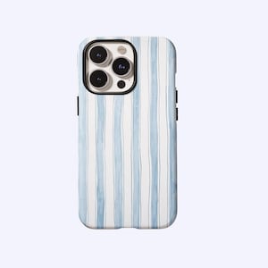 May include: A smartphone case with a watercolor-style design. The case features vertical stripes in light blue and white. The case has a black border around the camera and black buttons on the side.