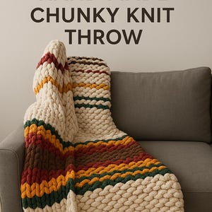 May include: A hand-made, chunky knit throw blanket in cream, brown, green, and yellow stripes is draped over a gray sofa. The text "AUTUMN INSPIRED HAND MADE CHUNKY KNIT THROW" is at the top of the image.