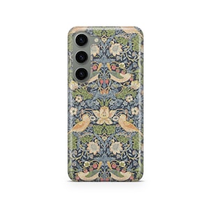 May include: A phone case with a floral and bird pattern in shades of blue, green, and beige. The design features stylized birds, flowers, and berries. The case has a camera module with three lenses.