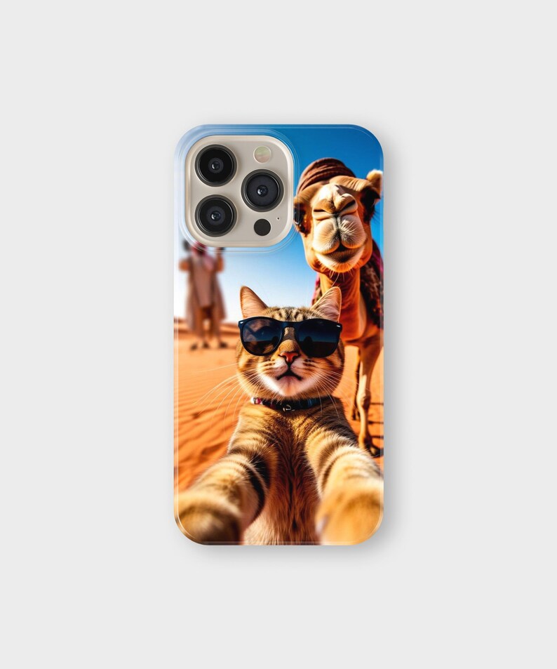 May include: A phone case featuring a selfie of a cat wearing sunglasses with a camel in the background. The cat is brown and tan with black sunglasses. The camel is brown and wearing a hat. The background is a desert scene.