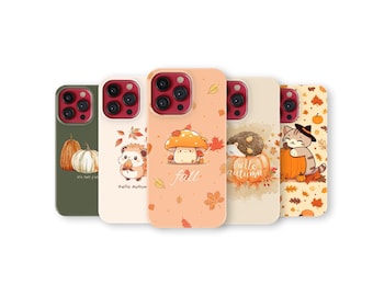 May include: Five colorful phone cases with autumn-themed designs. The cases feature illustrations of pumpkins, hedgehogs, mushrooms, and a cat, with fall leaves and the words "fall" and "hello autumn".