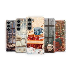 May include: Five phone cases with winter-themed illustrations. Designs include a snowy window, a stack of books with a mug, and a person reading by a Christmas tree. The cases are in various shades of brown, white, and red.