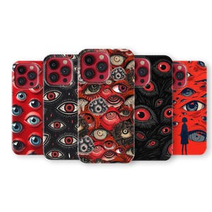 May include: Five phone cases with striking eye designs. The cases showcase a range of colours, including red, black, and white, with detailed eye illustrations. One case features a person's silhouette.