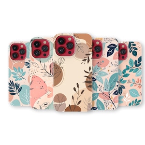 May include: A collection of phone cases with floral designs. The cases feature a variety of patterns with leaves, branches, and abstract shapes in shades of pink, blue, and brown. The phone cases have a red camera lens.