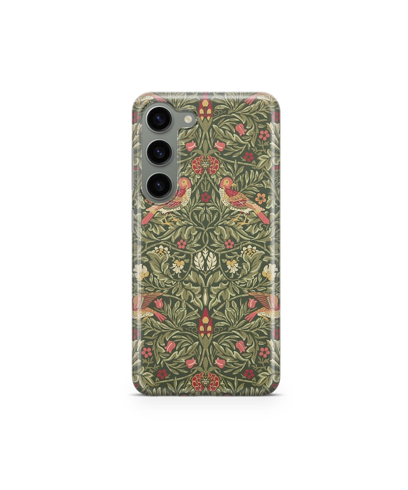 May include: A phone case with a detailed floral and bird pattern in shades of green, red, and cream. The design features stylized birds and flowers, creating a vintage aesthetic. The case has a glossy finish and a camera cutout.