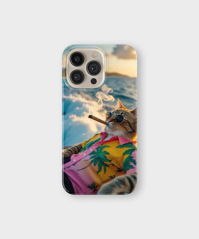 May include: A phone case featuring a cat wearing sunglasses and a Hawaiian shirt, smoking a cigar. The shirt is pink and yellow with a palm tree design. The background shows a seascape with a sunset.