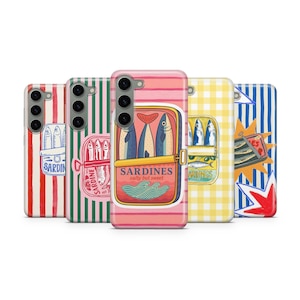 May include: A collection of phone cases with sardine can designs. The cases feature various patterns, including stripes, checks, and illustrations of sardines. The central case displays a pink background with a sardine can graphic and the text "Sardines, salty but sweet."