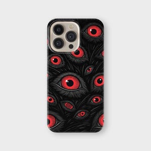 May include: Black phone case with a repeating pattern of red eyes and black details. The eyes have a detailed, stylized design, set against a dark background. The case has a glossy finish and a camera cutout.