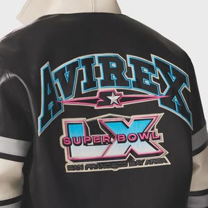 May include: Black and white leather jacket with the word "AVIREX" in blue and pink lettering across the back. Below the word "AVIREX" is a star and the words "SUPER BOWL LX" and "SAN FRANCISCO BAY AREA". The jacket has gray and white stripes on the sleeves.
